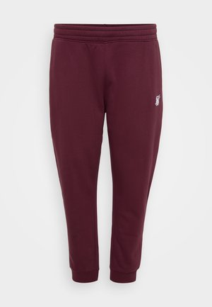 Burgunderfarbene Sweatpants aus weichem Stoff, mit einem elastischen Bund, Bündchen an den Knöcheln und einem kleinen gestickten Logo am linken Oberschenkel.