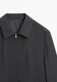 Dark gray collared jacket with subtle check pattern and a silver front zipper closure shown from the upper front on a light background.
