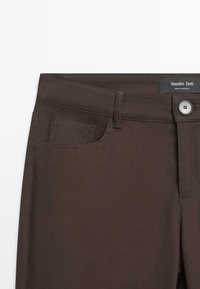 Dark brown pants with front button, belt loops, and a small front pocket, labeled Massimo Dutti, made in Morocco.