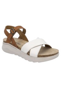 White leather sandal with brown leather straps and buckle, featuring a comfortable footbed and thick white rubber sole. Crossed strap design.