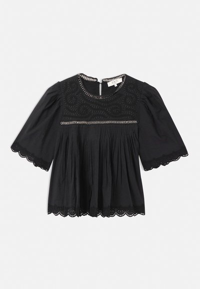 Black short-sleeve blouse with lace trim on sleeves and hem, embroidered yoke, pleated front, and chain detail along neckline and chest.
