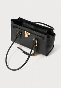Black leather handbag with a structured shape, gold hardware, zip closure, dual handles, and a textured, patterned accent strap.