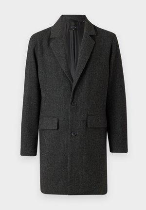 Schwarzer Wollmantel im Fischgrätmuster mit Reverskragen, einreihiger Knopfverschluss und zwei vorderen Taschen. Glatte Innenfutter.