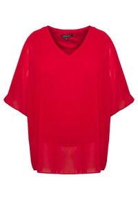 Blouse rouge ample en tissu léger et transparent, avec un col en V et des manches larges. Design simple sans ornements.