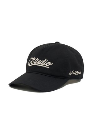 Black baseball cap with curved brim, embroidered with white "studio" on the front and smaller white script text on the side.