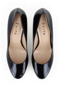 Scarpe con tacco alto in vernice nera, con punta affilata, finitura liscia e lati cut-out, caratterizzate da un interno nude con il nome del marchio "EVITA" inciso.