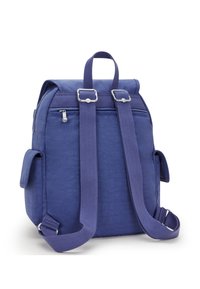 Purple fabric backpack with a roll-top closure, adjustable straps, and silver hardware. Features side pockets and a textured finish.