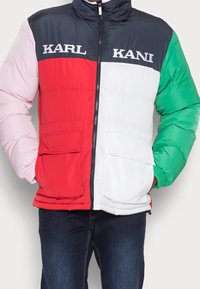 Podszewkowa kurtka z kontrastowymi sekcjami: granatowym, różowym, czerwonym, białym i zielonym. Posiada dwie przednie kieszenie i wysoki kołnierz. Logo na piersi.