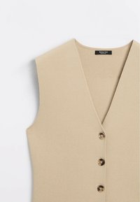 Beige ärmellose Weste mit V-Ausschnitt, drei Schildpattknöpfen und strukturiertem Stoff, Marke Massimo Dutti.