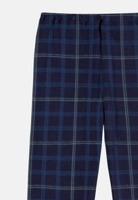 Navy blue plaid pajama pants featuring light blue and yellow lines, made from soft fabric with an elastic waistband for comfort.