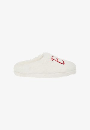 White fluffy slipper with a soft texture, rounded shape, and open back. Features red embroidered design on the front.
