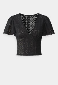 Schwarzes, kurzärmeliges Oberteil mit tiefem V-Ausschnitt und komplizierten Cut-Out-Mustern. Hat eine figurbetonte Silhouette und strukturierte Stoffoberfläche.