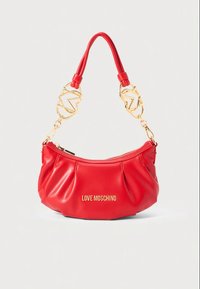Red leather handbag with gathered design, gold-tone logo, and chain strap featuring red accents. Zipper closure at the top.