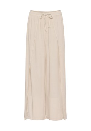 Beige levelekkisiä housuja, jotka on valmistettu kevyestä kankaasta. Niissä on joustava vyötärö, jossa on naru, ja sivuaukoja lisäämään tyyliä.