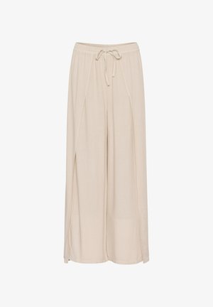 Beige levelekkisiä housuja, jotka on valmistettu kevyestä kankaasta. Niissä on joustava vyötärö, jossa on naru, ja sivuaukoja lisäämään tyyliä.