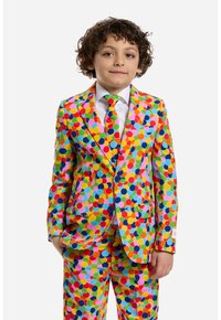 Completo dai colori vivaci con pois multicolori su uno sfondo giallo, con una cravatta coordinata e due bottoni blu.