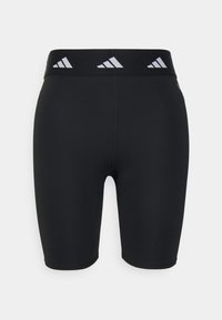 Pantaloni sportivi neri con un design aderente, realizzati in materiale elastico. Presentano una cintura larga nera con accenti bianchi del marchio.