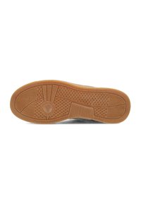 Rubber shoe sole with a textured surface, featuring a circular logo in the center and various pattern designs in light brown.