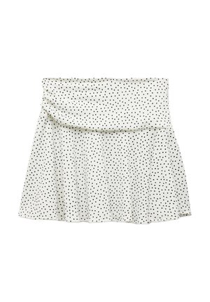 Hvid nederdel med sorte prikker, med en indsamlet talje og en udvidet kant. Lavet af blødt stof, har den en glat tekstur.