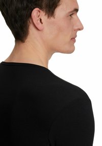 Black long-sleeve shirt made from soft fabric, featuring a crew neckline and seamless shoulder design without visible branding or patterns.