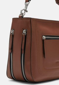 Brown leather handbag with silver hardware, featuring two zippered pockets, contrasting stitching, and a structured design.