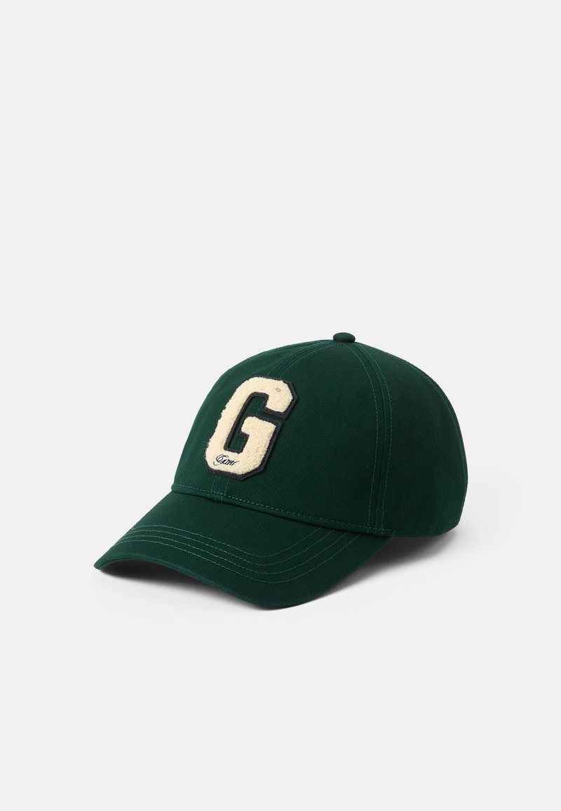Zelená bejzbalová čiapka z látky, s vyvýšeným krémovým logom "G" vpredu, zakriveným šiltom a prešitím.