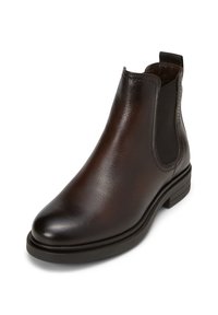 Botte Chelsea en cuir brun avec panneaux latéraux en élastique, bout arrondi et petit talon empilé. Texture lisse et détails de couture minimalistes.