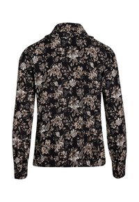 Camisa de manga larga con un fondo negro y un patrón floral en tonos beige y blanco. Tejido suave con cuello y cierre de botones.