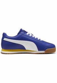 Puma-sneakers med blå syntetisk ovandel, vita detaljer och gul sula. Utrustad med gummisula och vita skosnören för att säkra passformen.