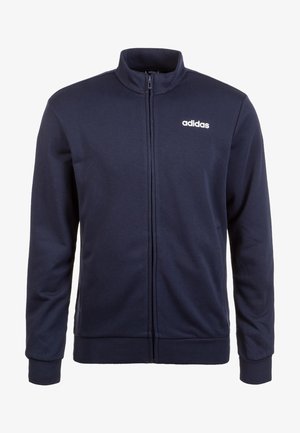 Veste zippée bleu marine en tissu lisse, avec un col montant et le logo Adidas blanc sur la poitrine en haut à gauche. Manches longues avec des poignets.
