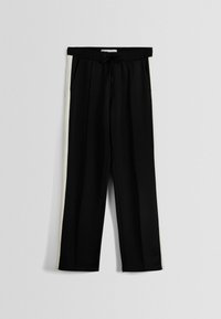 Svarta träningsbyxor med elastisk midja och dragsko, med krämfärgade sidpaneler och ett mjukt, lättviktigt tyg.