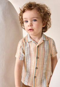 Short-sleeve, textured shirt with vertical stripes in cream, orange, light blue, and peach, featuring brown buttons and a pointed collar.