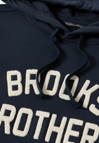 Námořnická modrá mikina s texturovaným slonovinovým logem "BROOKS BROTHERS", nastavitelnými námořnickými stahovacími šňůrkami a měkkou bavlněnou směsí.