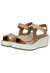 Beige faux leather wedge sandals with two adjustable straps, open toe, and a white rubber sole. Features a subtle gold accent detail.