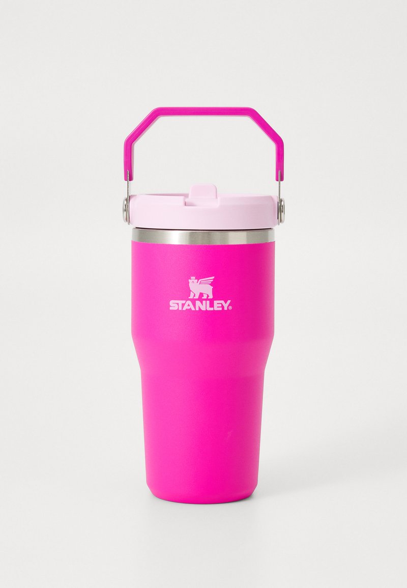 Pink stainless steel travel mug with a tapered body, pink handle, and a light pink lid featuring a small spout for drinking.