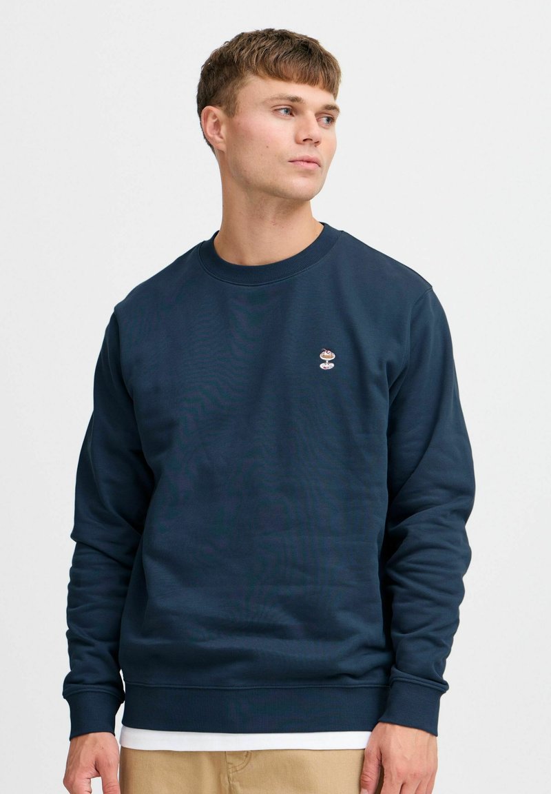 Navyblauwe sweatshirt van katoen, met een ronde hals en geribbelde manchetten. Beschikt over een klein geborduurd logo op de borst.
