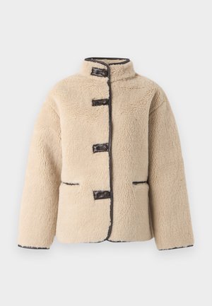 Cream-colored faux fur jacket with a high collar, button closure, and dark trim. Features two front pockets and a boxy silhouette.
