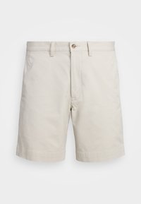 Béžové bavlněné šortky s klasickým střihem. Mají zapínání na knoflík, boční kapsy a ohrnuté zakončení pro čistý vzhled. Hladká, lehká textura.