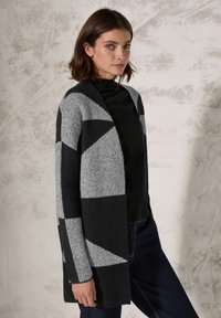 Gebreide cardigan in grijs en zwart met een geometrisch patroon, open ontwerp aan de voorkant, lange mouwen en een zachte, gestructureerde afwerking.