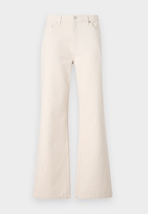 Beżowe dzwony wykonane z bawełny, z wysokim stanem, pięcioma kieszeniami oraz subtelną teksturą z gładkim wykończeniem.