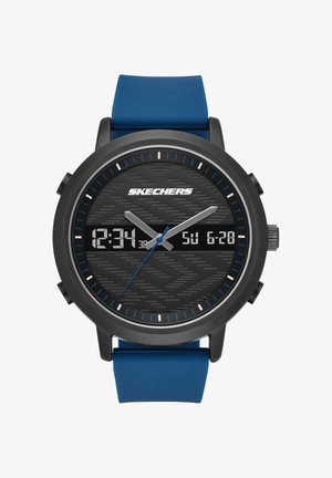 Montre ronde noire Skechers avec un bracelet en silicone bleu affichant l'heure analogique 12:34:37 et la date numérique dimanche 28 juin sur un cadran texturé.