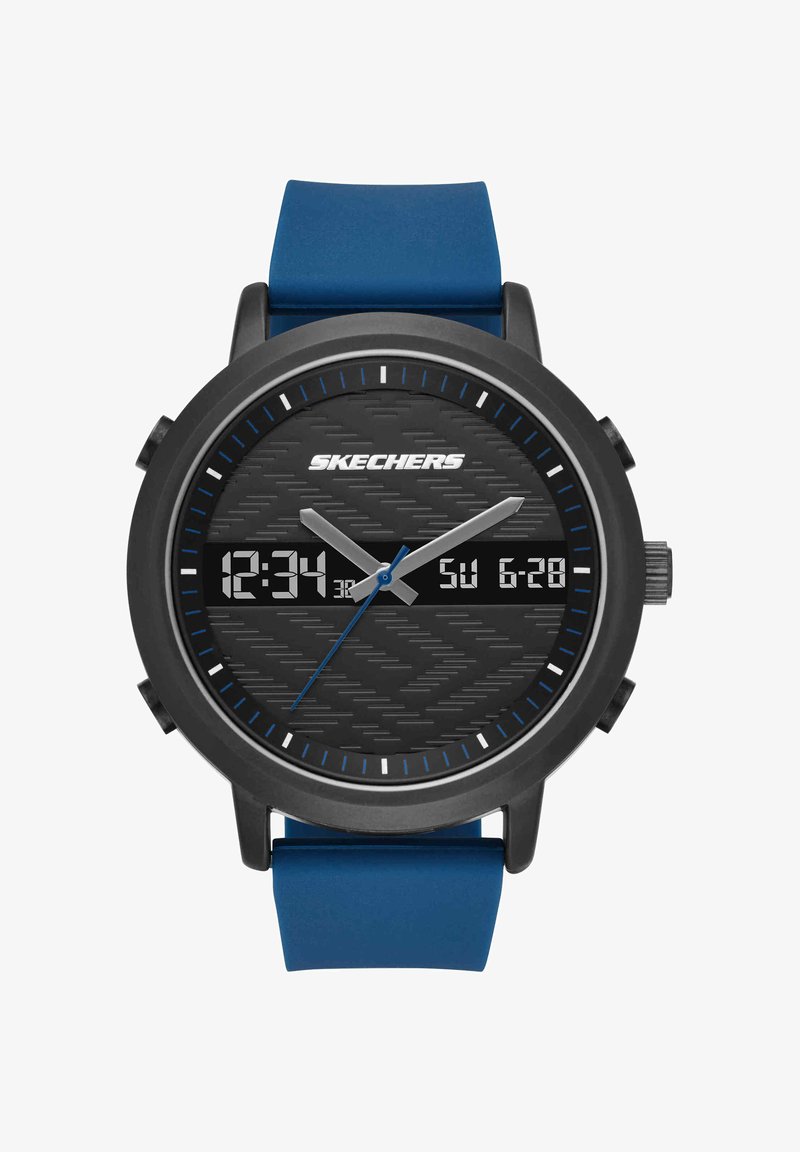 Montre ronde noire Skechers avec un bracelet en silicone bleu affichant l'heure analogique 12:34:37 et la date numérique dimanche 28 juin sur un cadran texturé.