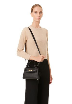 Black leather handbag with a structured shape, featuring a top handle and a detachable shoulder strap. Gold accent hardware.