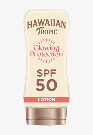Hawaiian Tropic Glowing Protection SPF 50 lotion in een beige knijpfles met een bruine dop en een rode accentband.