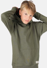 Vihreä huppari, pehmeää materiaalia, suuri etutasku, hupullinen muotoilu, ribbikuvioidut hihansuut, hienovarainen rakenne, brändilogo helman kohdalla.