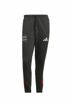 Pantalones deportivos negros con detalles laterales rojos, cintura elástica, estampados de logotipo en gris y puños acanalados. Hechos de tela suave y texturizada.