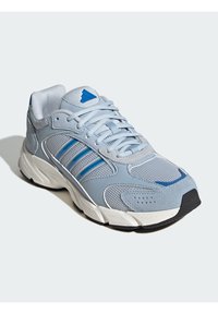 Light gray athletic shoe with blue accents, mesh and suede materials, lace-up design, and a textured rubber sole.