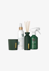 Green and white scented home products include a ribbed candle, reed diffuser, refreshing spray, and interior perfume spray bottle.
