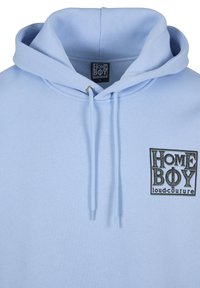 Light blue hoodie with drawstrings and a black "HOME BOY loud-couture" logo printed on the left chest.