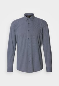 Chemise habillée pour homme à manches longues, coupe slim, boutonnée, avec un petit motif géométrique blanc sur tissu bleu foncé.